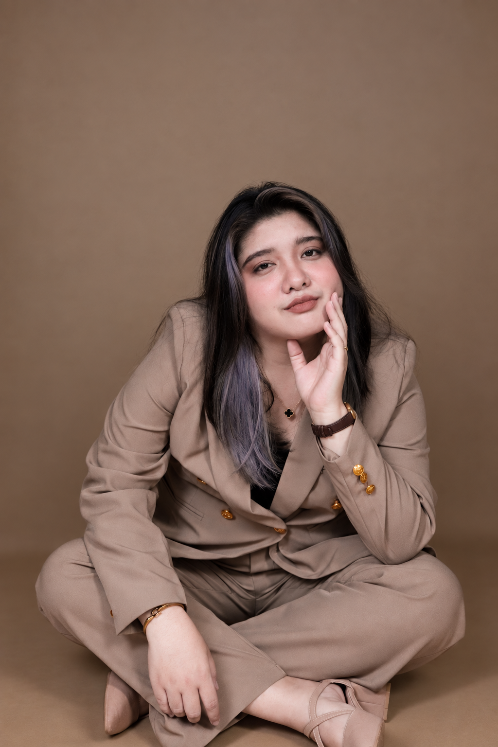 Angela Alvarez in a brown suit