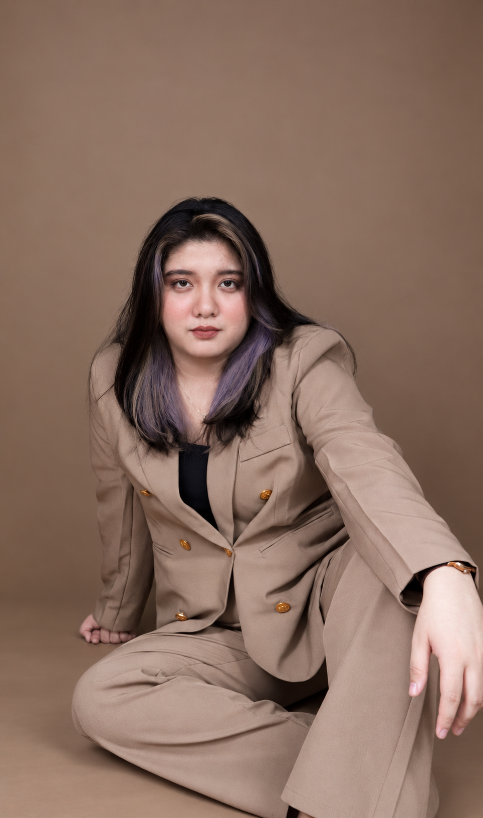Angela Alvarez in a brown suit